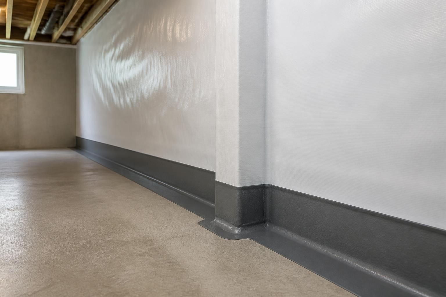 Dry basement with clean finished waterproofing details.