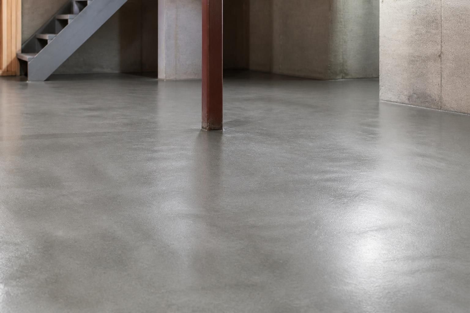 Smooth repaired basement floor with a clean finished surface.